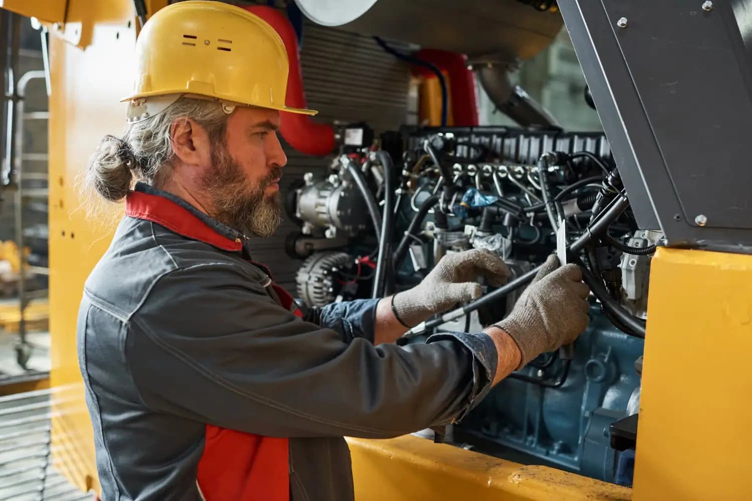 Mechanic servicing heavy equipment
